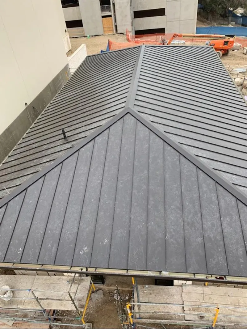 Commercial metal roof construction with crane equipment in New Kingman-Butler