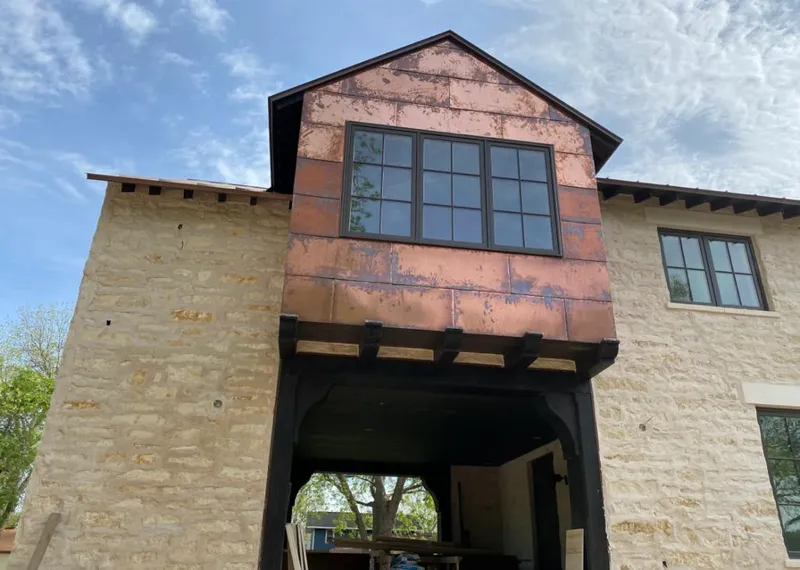 Copper metal panel facade on a stone building for Roof Repair in New Kingman-Butler